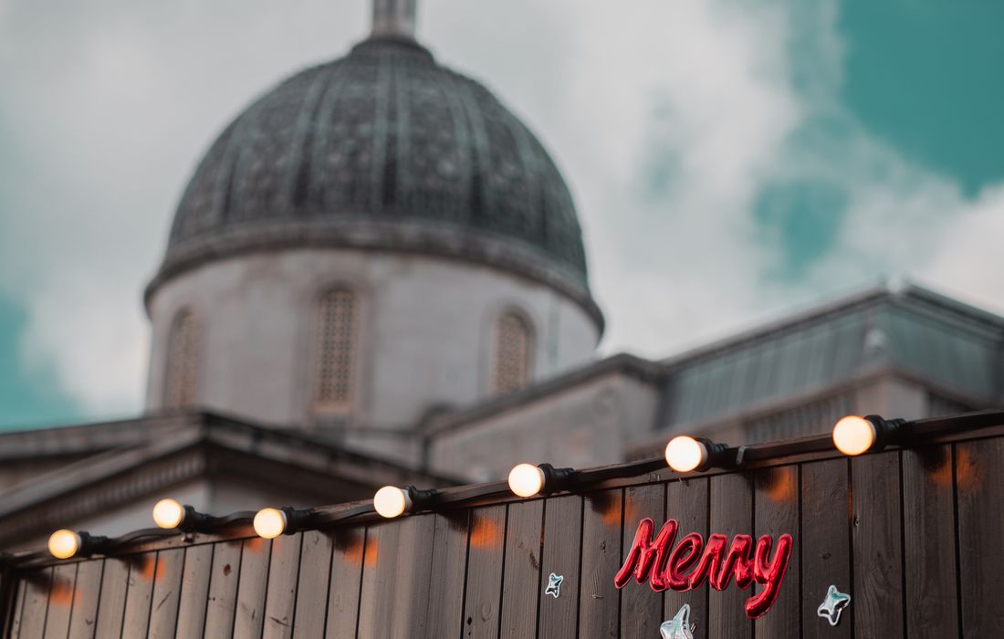 Christmas market stalls in London with St Paul's dome behind, how to save money in London at Christmas