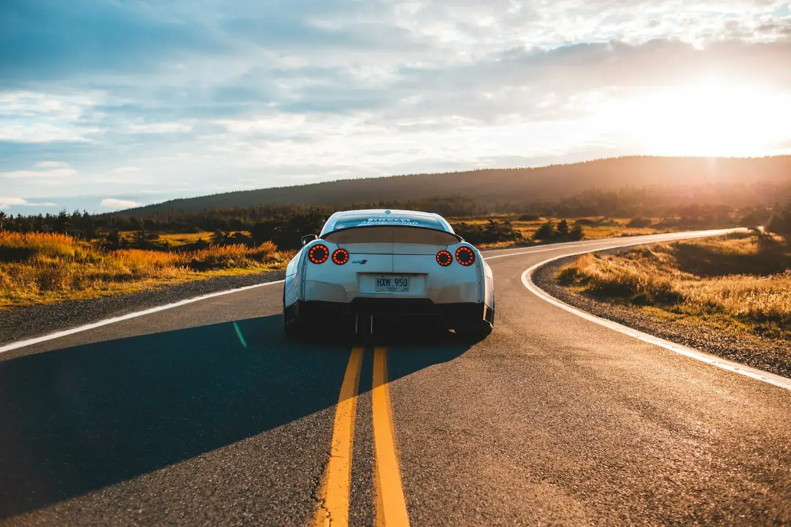 Car on an open road at sunset - the drive from London City Airport to London